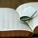 Open book and magnifying glass, symbolizing research and education.