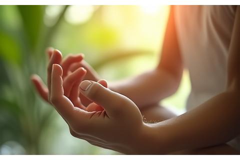 Someone meditating peacefully with glowing natural light around them, symbolizing inner calm and stress relief.